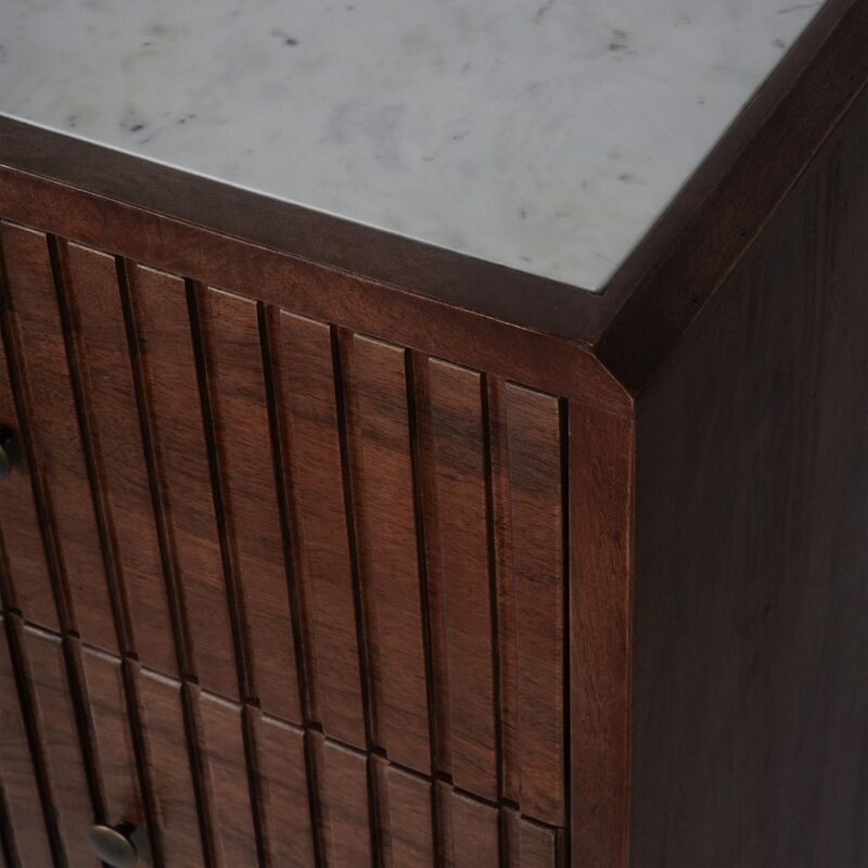 Close-up of a wooden cabinet with a marble countertop