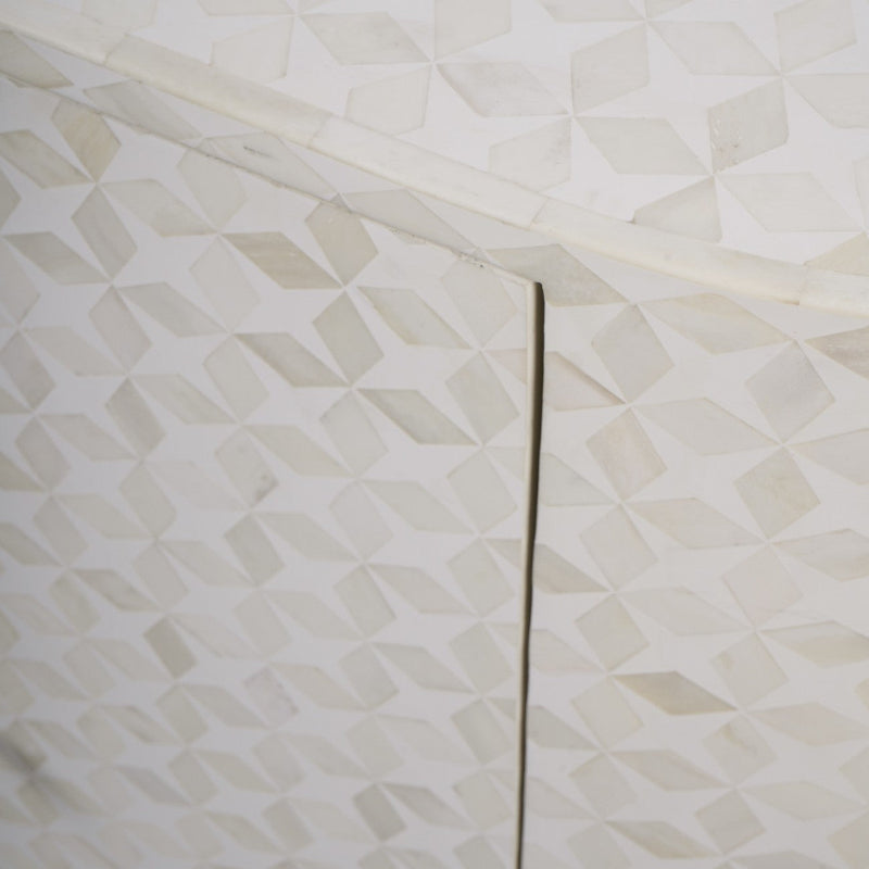 Close-up of a textured white surface with geometric patterns