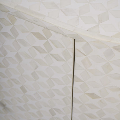 Close-up of a textured white surface with geometric patterns