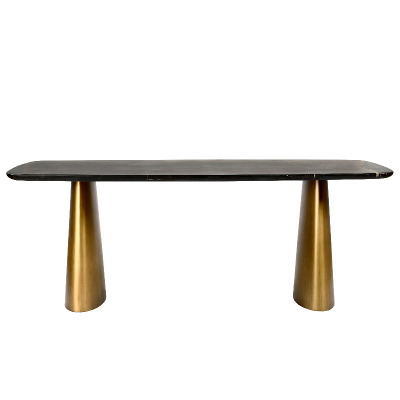 Dining table with black marble top and gold metal legs on a white background