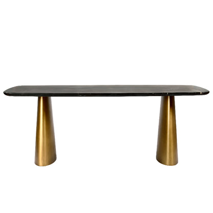 Dining table with black marble top and gold metal legs on a white background