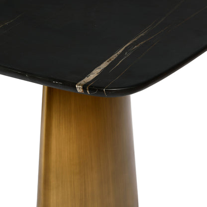 Close-up of a black marble table top with a gold metal base on a white background