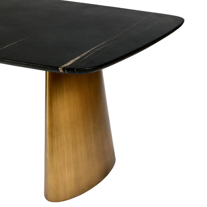 Dining table with black marble top and gold metal base on a white background
