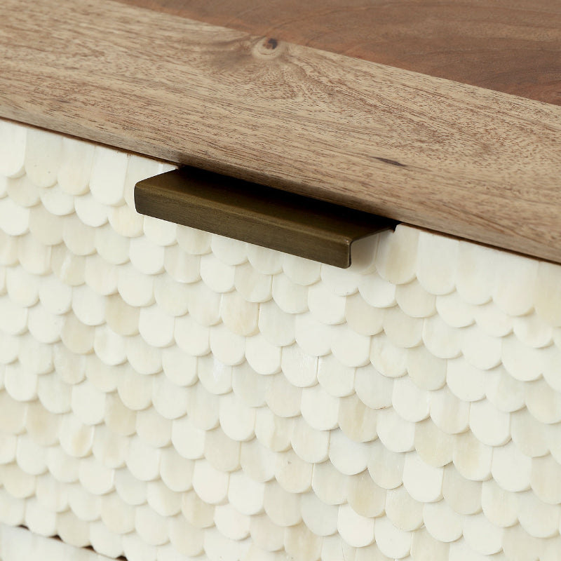 Close-up of a wooden drawer with a metal handle on a textured white surface