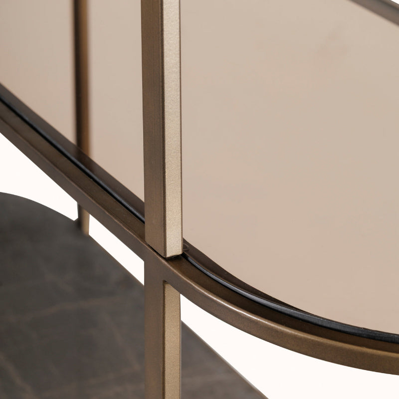 Close-up of a modern round table with metallic legs and beige top.