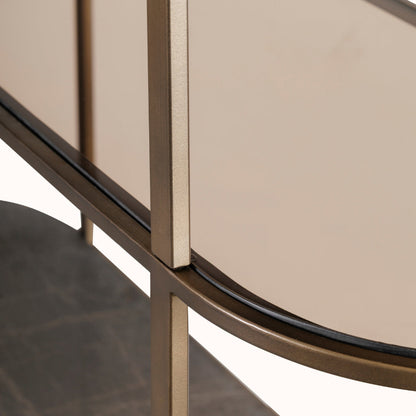 Close-up of a modern round table with metallic legs and beige top.