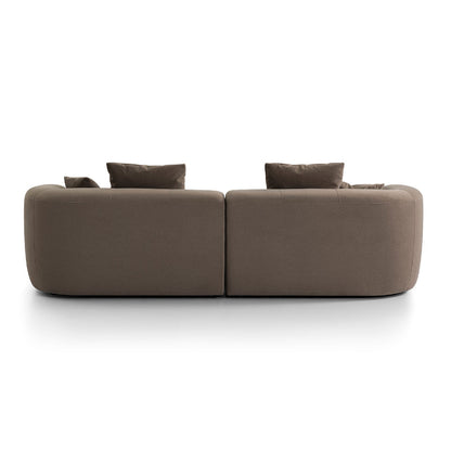 Brown sofa with two cushions on a white background