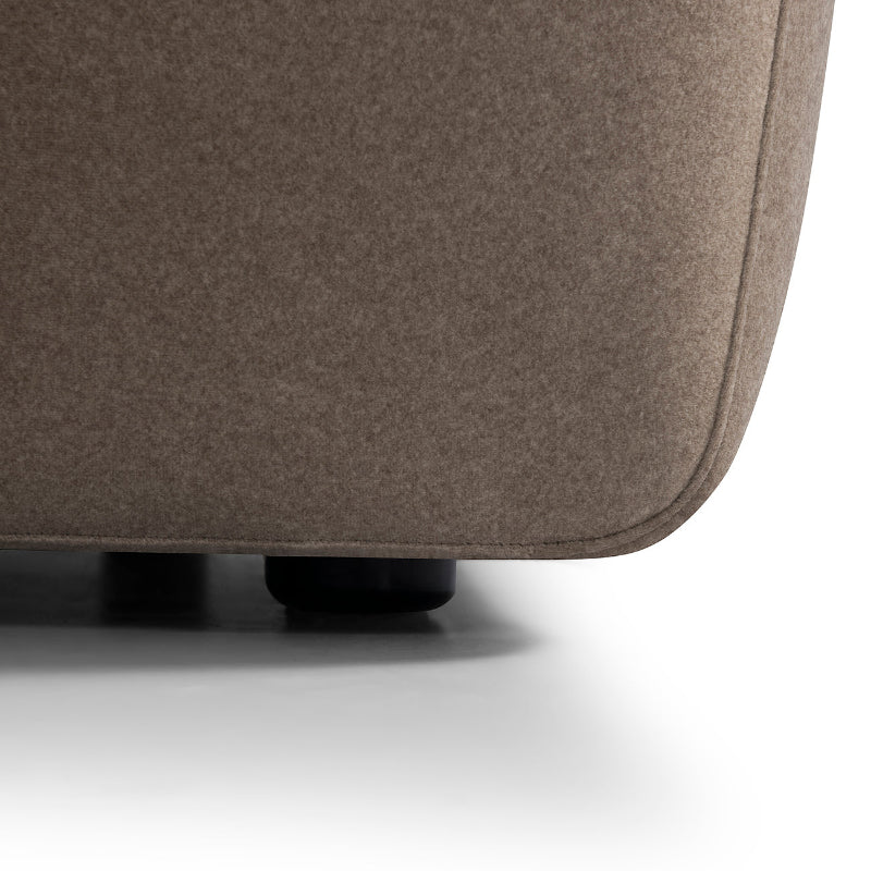 Close-up of a brown upholstered chair corner on a white background