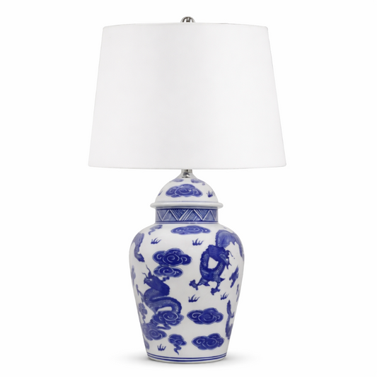 Blue and white ceramic table lamp with a white shade on a white background