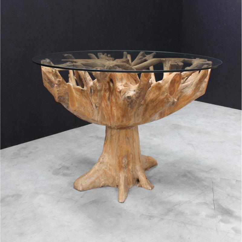 Glass-top table with natural wood base on a gray surface with black background