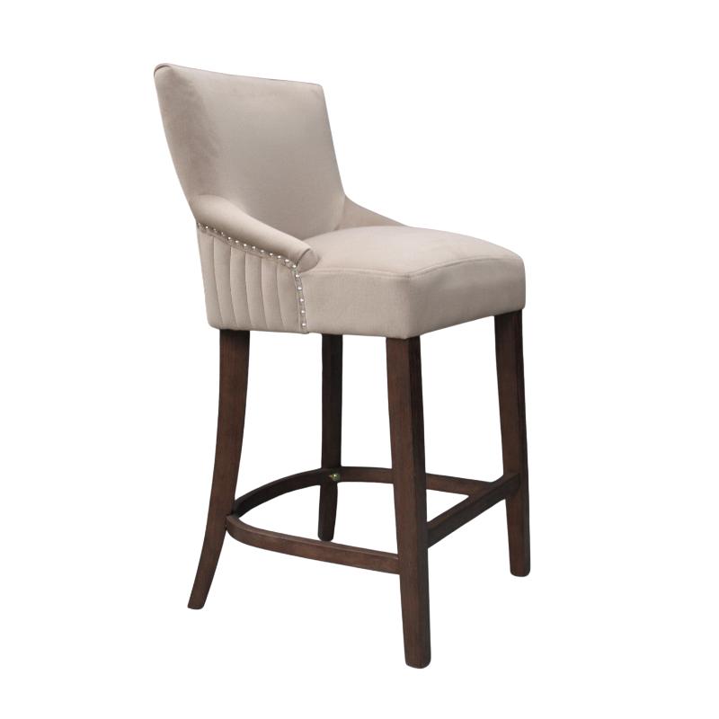 A single upholstered bar stool with a light beige velvet seat and backrest, dark brown wooden legs, and silver nailhead trim on the armrests, shown against a plain white background.