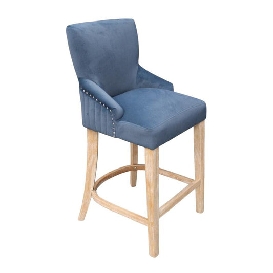 A blue velvet upholstered bar stool with a light natural wood frame and silver nailhead trim on the armrests, shown against a plain white background.