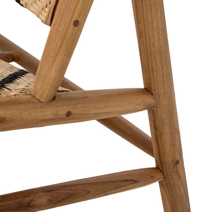 Close-up of a wooden chair with wicker backrest on a white background