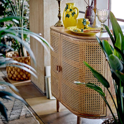 Wicker sideboard with decorative items in a home setting