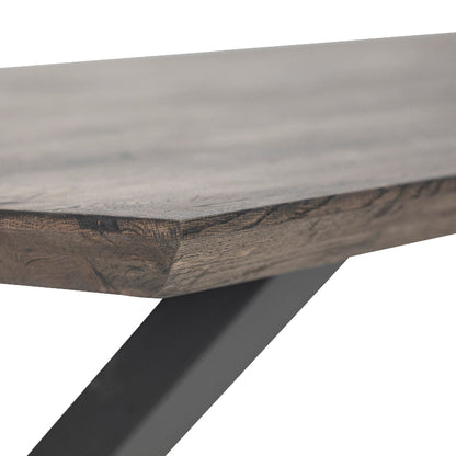 Wooden table with a dark metal leg on a white background