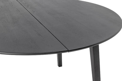Round dark gray dining table with a visible grain pattern on a white background