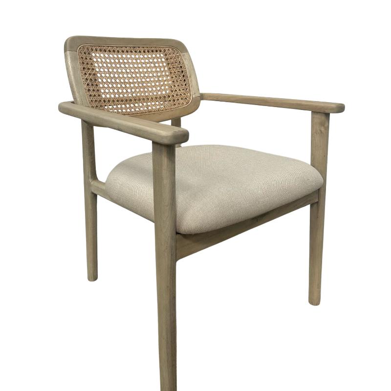 A modern armchair with a light natural wood frame, a woven cane backrest, and a light beige upholstered seat cushion, shown against a plain white background.
