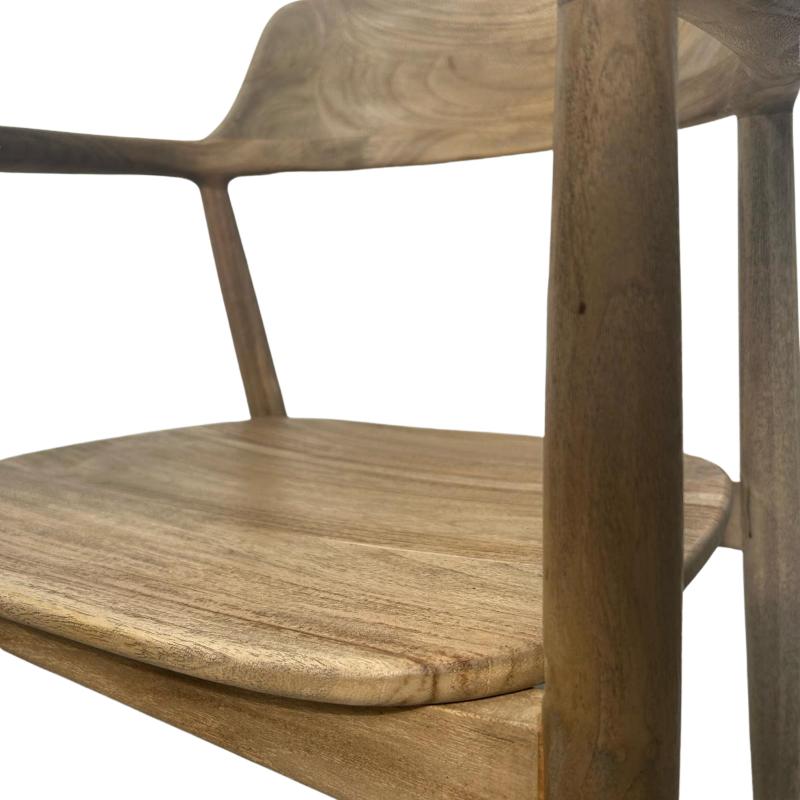 A close-up of a wooden armchair showing the seat, backrest, and thick wooden legs against a plain white background.