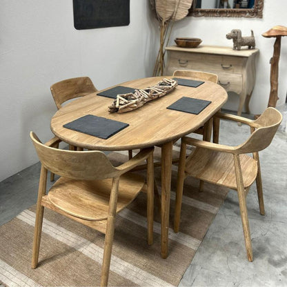 Dining area with wooden table and chairs in a room with decorative elements.