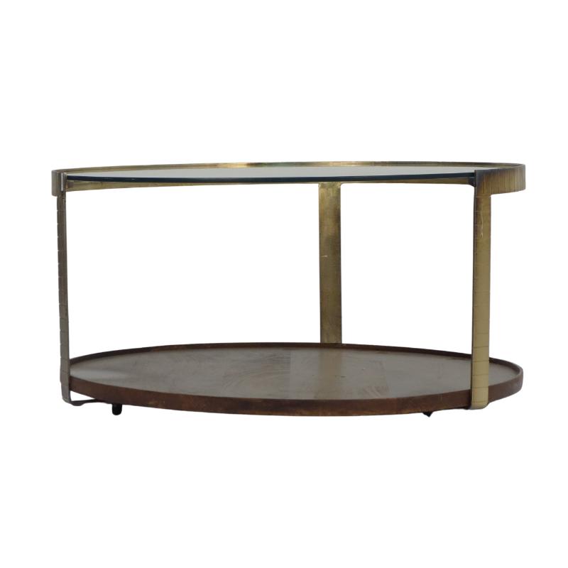 An oval two-tier coffee table with a dark brown wood lower shelf and a clear glass upper tier supported by a brass-finished metal frame, shown against a plain white background.