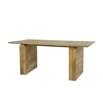 A rustic wooden table with a rectangular light brown tabletop and two thick, blocky legs made from stacked wooden planks, shown against a plain white background.