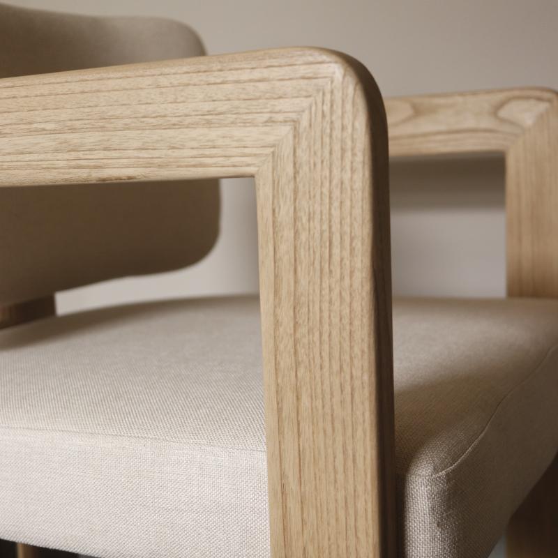 Close-up of a modern dining chair with light natural wood frame and beige textured fabric upholstery.