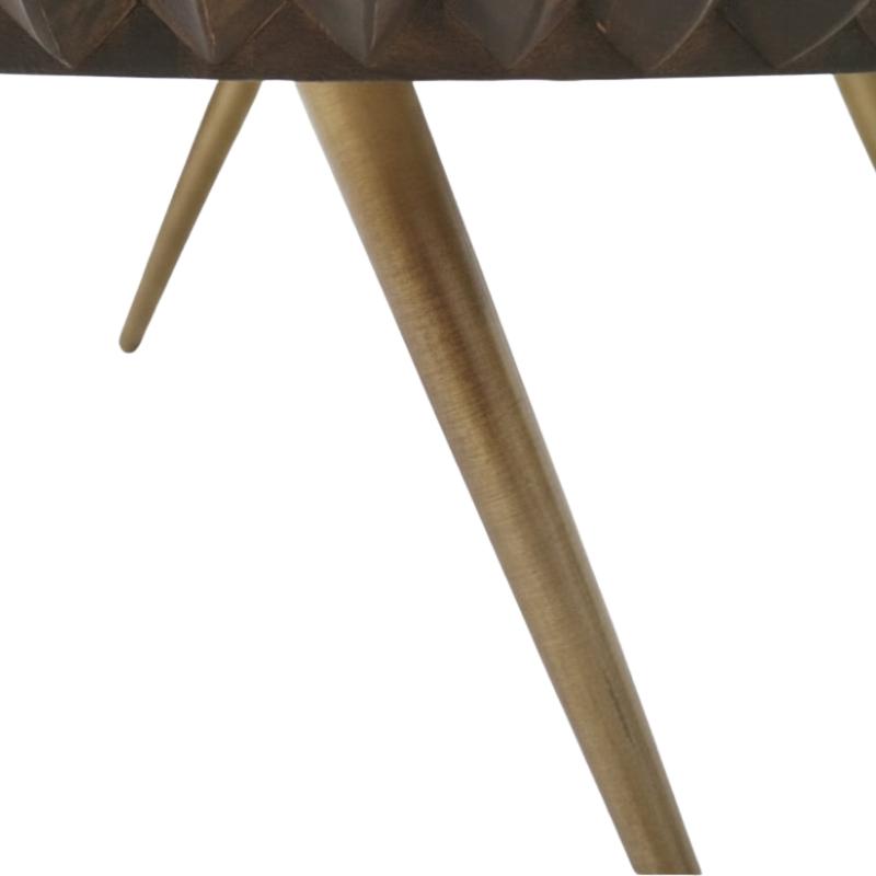 Close-up of a table leg with a brushed gold finish and a dark brown faceted seat surface against a white background.