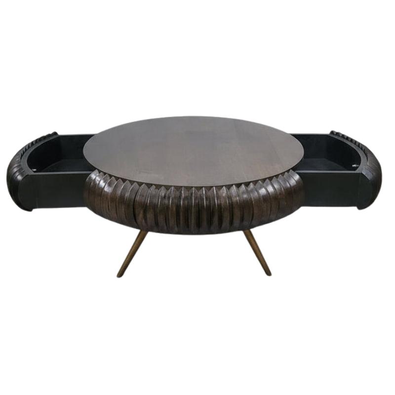 A modern round coffee table with a dark textured central body, a smooth circular top, and integrated side drawers on a white background.