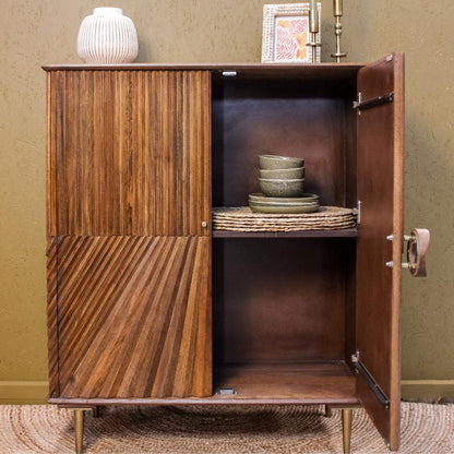 Wooden cabinet with open door displaying interior shelves against a beige wall.