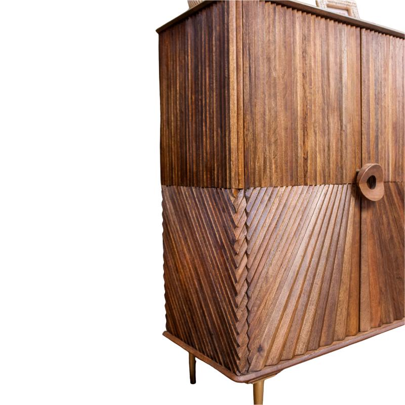 A mid-century modern wooden cabinet featuring a mix of vertical and chevron carved wood panels, supported by slim metal legs, shown against a plain white background.