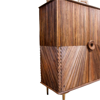 A mid-century modern wooden cabinet featuring a mix of vertical and chevron carved wood panels, supported by slim metal legs, shown against a plain white background.