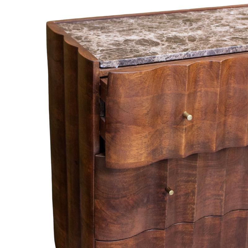 Close-up of a wooden console or credenza with a mottled stone top, scalloped drawer fronts, and small round metal pulls on a white background.