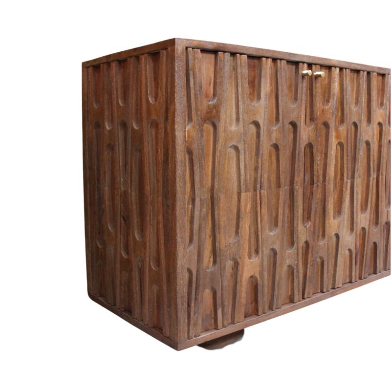 A rectangular wooden cabinet with two doors featuring a carved, vertically wavy textured pattern, finished in medium brown wood with a small brass handle, shown on a plain white background.