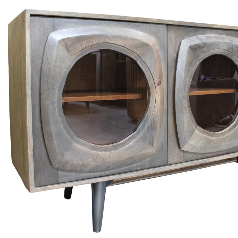Mid-century modern wooden credenza with two circular glass-front doors and tapered legs, shown against a plain white background.
