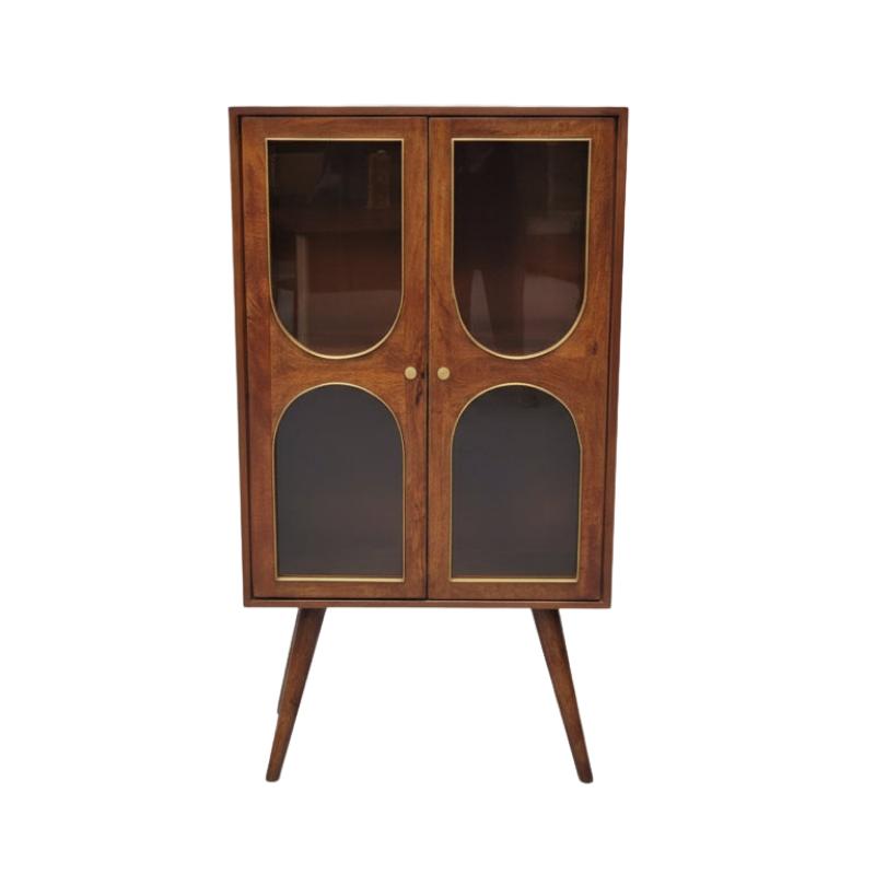 Mid-century modern wooden cabinet with glass doors, gold-tone trim, and tapered legs, photographed against a neutral gray background.