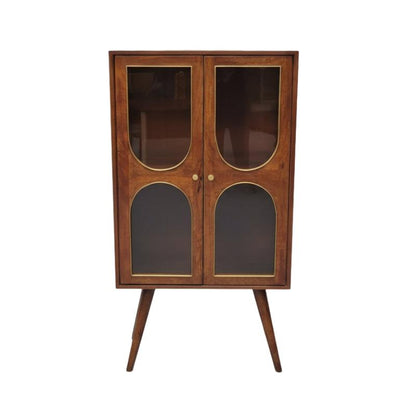 Mid-century modern wooden cabinet with glass doors, gold-tone trim, and tapered legs, photographed against a neutral gray background.