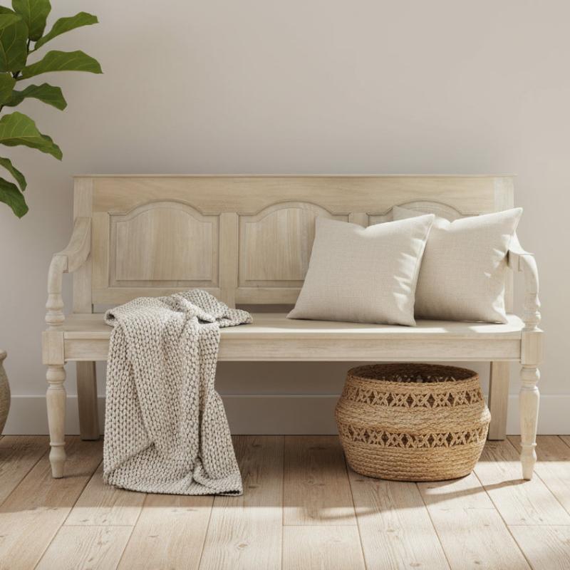 Beige bench with pillows and a blanket in a room with a plant and woven basket.