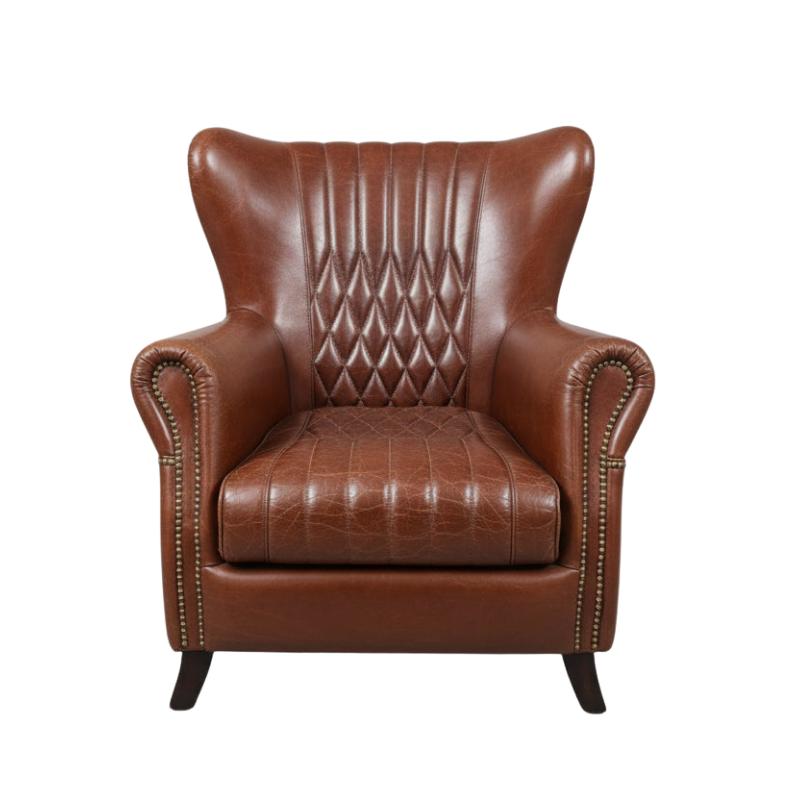 A classic brown leather wingback armchair with diamond-quilted backrest, tufted seat cushion, rolled nailhead trim, and dark tapered legs, shown against a plain white background.