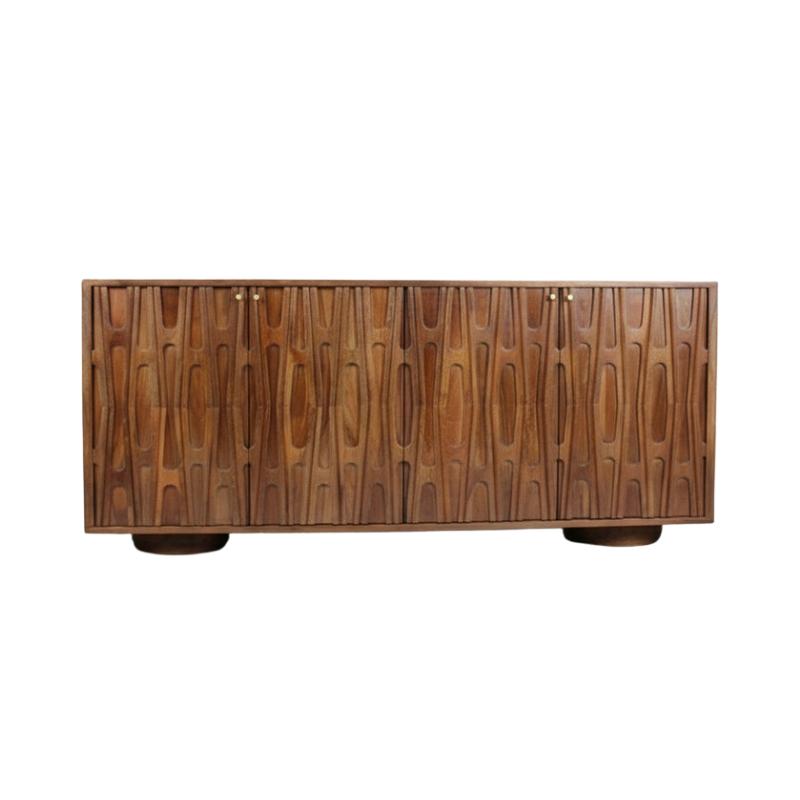 A mid-century modern wooden sideboard with a distinctive wavy, vertically grooved wood grain pattern on its doors, supported by four dark round feet, shown against a plain white background.