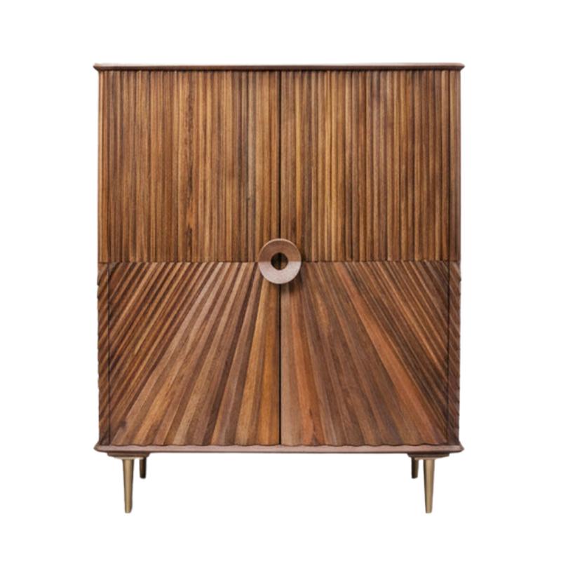 Mid-century modern wooden cabinet featuring a vertical fluted wood grain pattern on the upper doors and a radial sunburst design on the lower doors, with a circular metal pull handle and tapered metal legs.