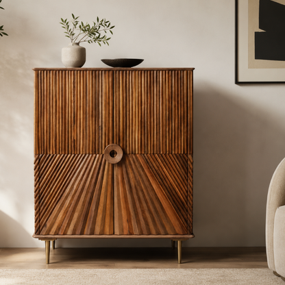 A mid-century modern wooden cabinet with vertically and radiating striped bamboo doors, styled in a warm, minimalist room next to a neutral chair.