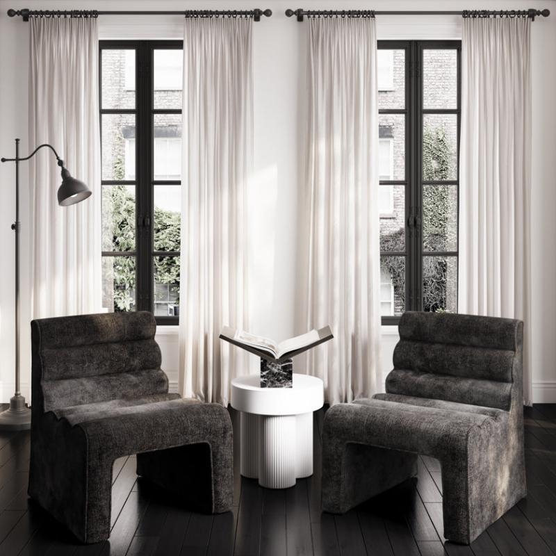 Modern interior with two gray cushioned chairs and a white side table.