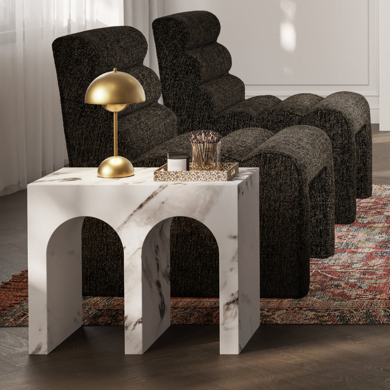 Modern living room with dark upholstered chairs and a marble side table.