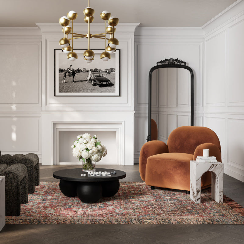 Modern living room with a brown armchair, black coffee table, and decorative elements.