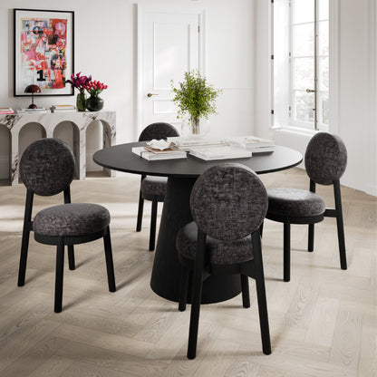 Dining room with a round black table and four gray chairs.