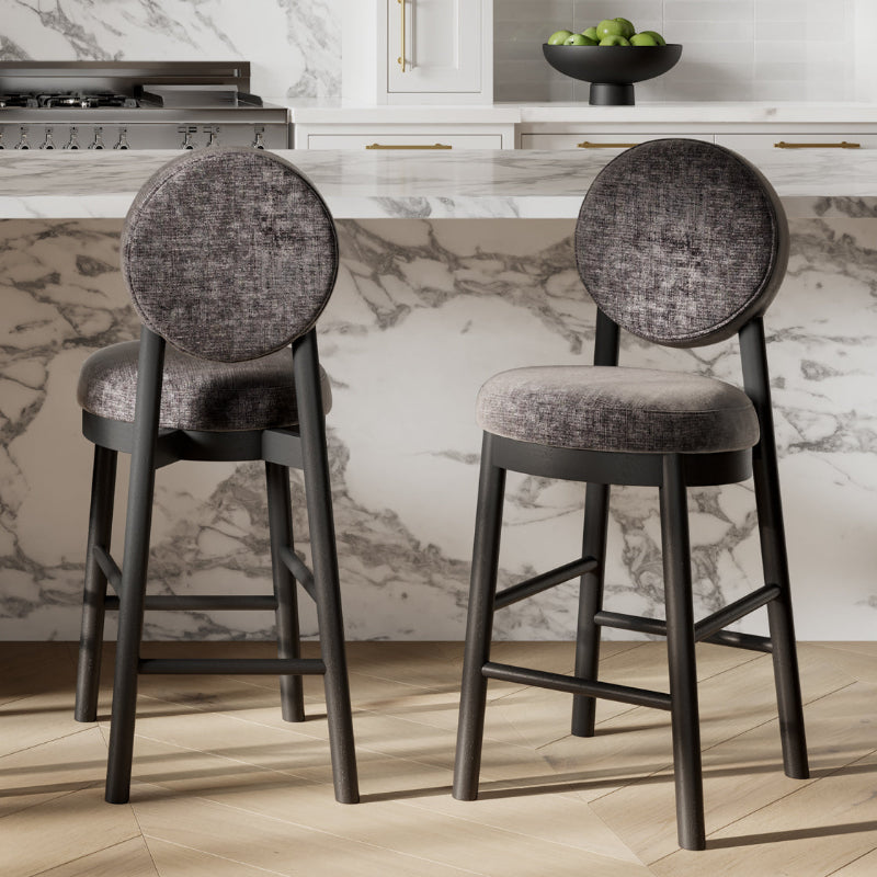 Two gray bar stools with round backs in a kitchen setting.