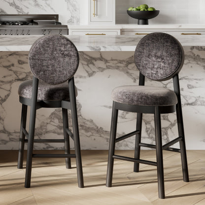 Two gray bar stools with round backs in a kitchen setting.