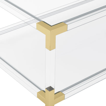 Clear Acrylic coffee table with gold metal legs on a white background
