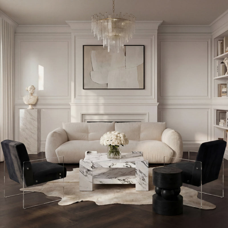 Modern living room with a beige sofa, black chairs, and a marble coffee table.