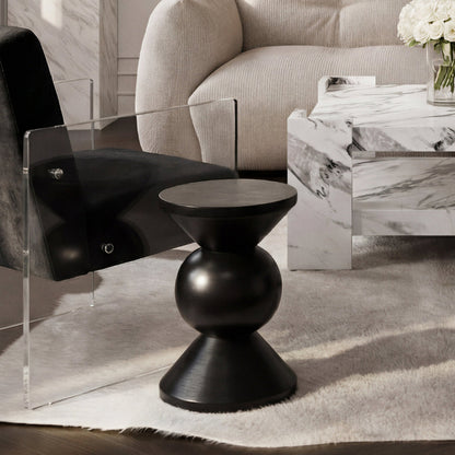 Modern living room with a black side table, clear chair, and marble coffee table.